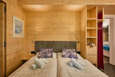 a bedroom with a bed in a wooden room at Alpin Relais B&B Villa Melisse in Colfosco