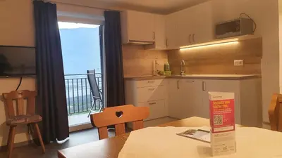 a small kitchen with a table and a window at Haus Sonnegg in Marlengo