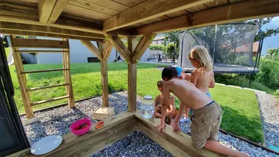 a group of people playing in a wooden pergola at Haus Sonnegg in Marlengo