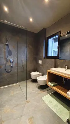 a bathroom with a shower and a sink and a toilet at Haus Sonnegg in Marlengo