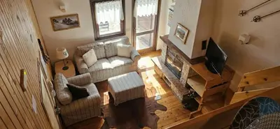 an overhead view of a living room with a couch and a television at Appartamento Le Pale in Alleghe