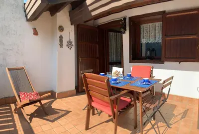 a dining room table and chairs in a house at Appartamento Le Pale in Alleghe
