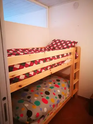 a bedroom with two bunk beds in a room at Dolomiti Di Brenta in Ronzone