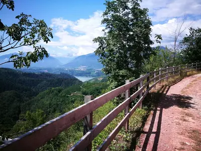 a path on a hill with a view of a valley at Dolomiti Di Brenta in Ronzone