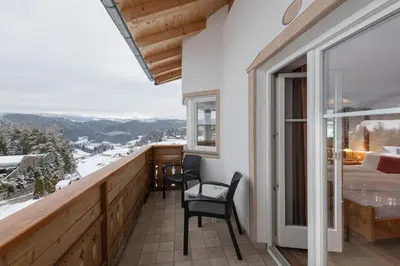 a balcony with a view of a bedroom and a bed at Cristallo B&B in Castelrotto