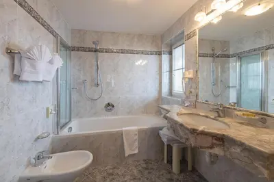 a bathroom with a tub and a sink and a bath tub at Cristallo B&B in Castelrotto