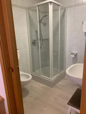 a bathroom with a shower and a toilet and a sink at B&B MARINA contacless check in in Santa Cristina in Val Gardena