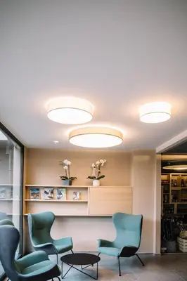 a waiting room with chairs and lights at Panoramic Suites Winzerhöhe in Schenna