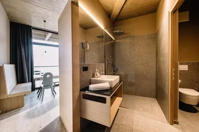 a bathroom with a sink and a toilet at Panoramic Suites Winzerhöhe in Schenna