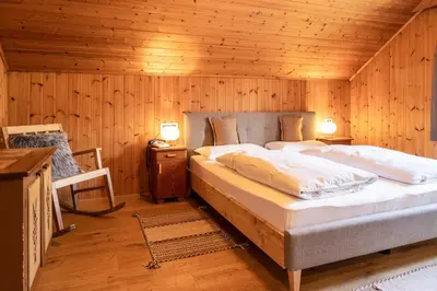 a bedroom with two beds in a wooden room at Villa Alba in La Villa