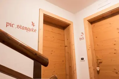 a room with a wooden door and a staircase at Villa Alba in La Villa