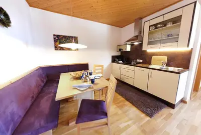 a kitchen and dining room with a table and chairs at Grumserhof in Merano