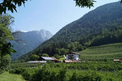 a village in a valley with mountains in the background at Grumserhof in Merano