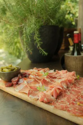 a pizza sitting on a table next to a bowl of food at Residence Fischerhof in Tirolo