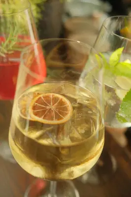 two glasses of wine with a orange slice in it at Residence Fischerhof in Tirolo