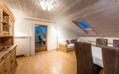 a kitchen and living room with a bed and a table at Residence Fischerhof in Tirolo