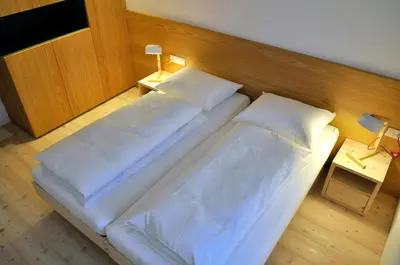 a large bed in a room with two pillows at Apartments Frieda in Valdaora