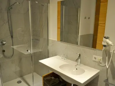 a bathroom with a sink and a shower at Apartments Frieda in Valdaora