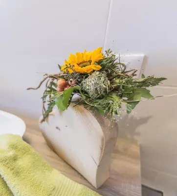 a vase with flowers in it sitting on a table at Ferienwohnung Eder in Gais