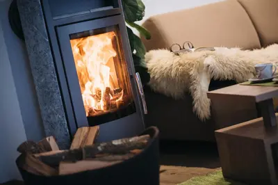 a fireplace with a fire in it in a room at Ferienwohnung Eder in Gais