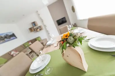 a table with a vase of flowers on top of it at Ferienwohnung Eder in Gais