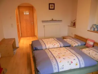 two twin beds in a room with a hallway at Unterweger Hof in Avelengo
