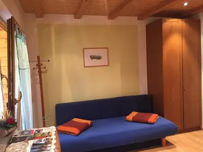 a blue couch with two pillows on it in a room at Unterweger Hof in Avelengo