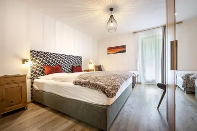 a bedroom with a large bed and a window at Apartments Woerndle in Siusi