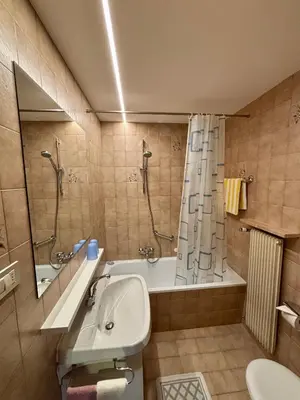 a bathroom with a tub and a shower and a sink at Residence Linde - Ferienwohnungen & Apartments in Castelrotto