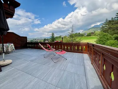 a pair of chairs sitting on the deck of a house at Residence Linde - Ferienwohnungen & Apartments in Castelrotto