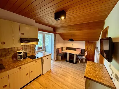 a kitchen with a table and a dining room at Residence Linde - Ferienwohnungen & Apartments in Castelrotto