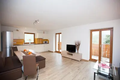 a living room with a couch and a kitchen at Appartement Bachguter in Avelengo
