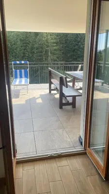 a view of a patio with a bench and a table at Appartement Bachguter in Avelengo