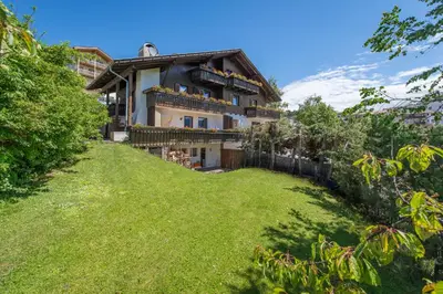 a house on a hill with a green yard at Garni-Residence Villa Paul in Nova Ponente