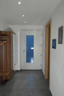 a hallway with a door and a tile floor at Appartement Fischnaller in Mühlbach