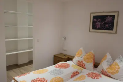 a bedroom with a bed with colorful pillows on it at Appartement Fischnaller in Mühlbach