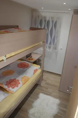 a bedroom with two bunk beds and a rug at Appartement Fischnaller in Mühlbach