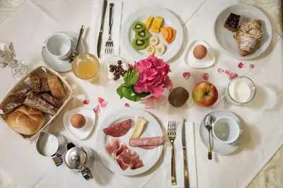 a white table topped with plates of breakfast food at Hotel Weisse Lilie - B&B in Mühlbach