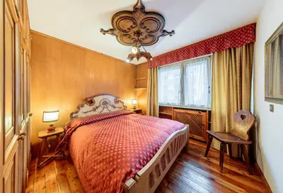 a bedroom with a large bed and a window at Villa Cristallino -Stayincortina in Cortina dʼAmpezzo