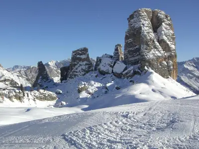 a snow covered mountain with rocks and snow at Villa Cristallino -Stayincortina in Cortina dʼAmpezzo