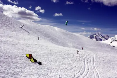 a group of people flying kites on a snow covered slope at Villa Cristallino -Stayincortina in Cortina dʼAmpezzo