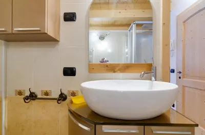 a bathroom with a large white sink on a counter at Cianbolpin Guesthouse in Canazei