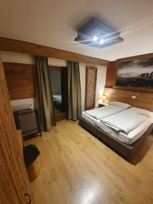 a bedroom with a large bed in a room at Garni Eden Bed and breakfast in Soraga
