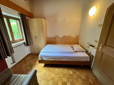 a small bedroom with a bed and a window at Garni Eden Bed and breakfast in Soraga