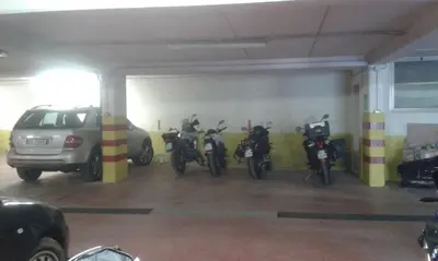 a garage with a bunch of motorcycles parked in it at Dolomiti Sport Hotel in San Vito di Cadore