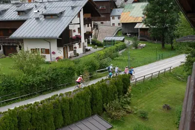 a group of people riding bikes down a road at Dolomiti Sport Hotel in San Vito di Cadore
