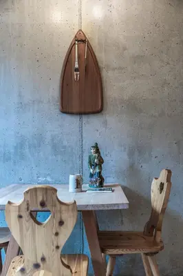 a wooden table and chairs with a table and a lamp at DESIGN APARTMENTS living Kampill in Bolzano