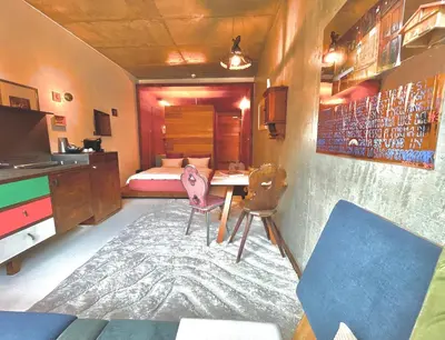 a bedroom with a bed and a desk and a table at DESIGN APARTMENTS living Kampill in Bolzano