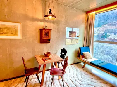 a living room with a table and a couch and a window at DESIGN APARTMENTS living Kampill in Bolzano