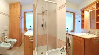 a kitchen with blue cabinets and a white refrigerator at Casa Rossi in Le Grazie